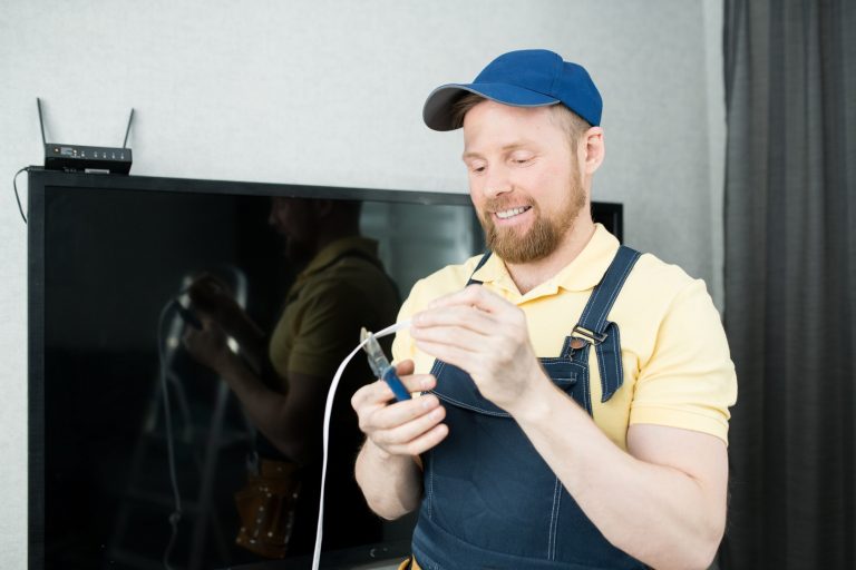 Cheerful guy cutting wire
